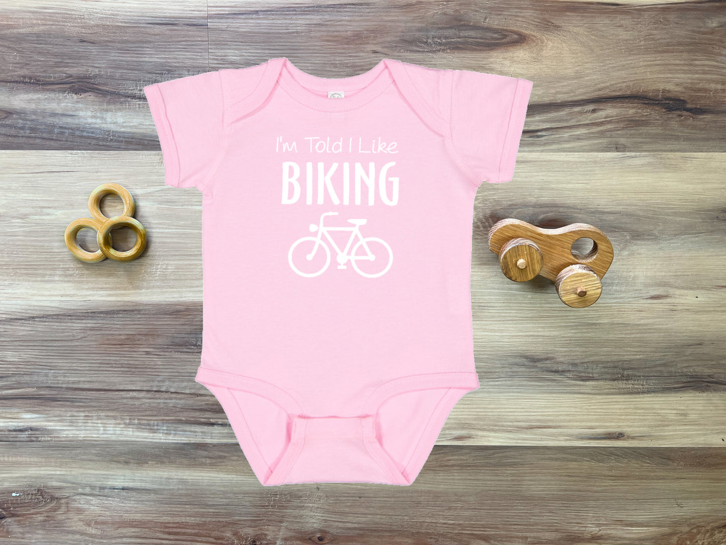 I'm Told I Like Biking Silhouette Baby Bodysuit